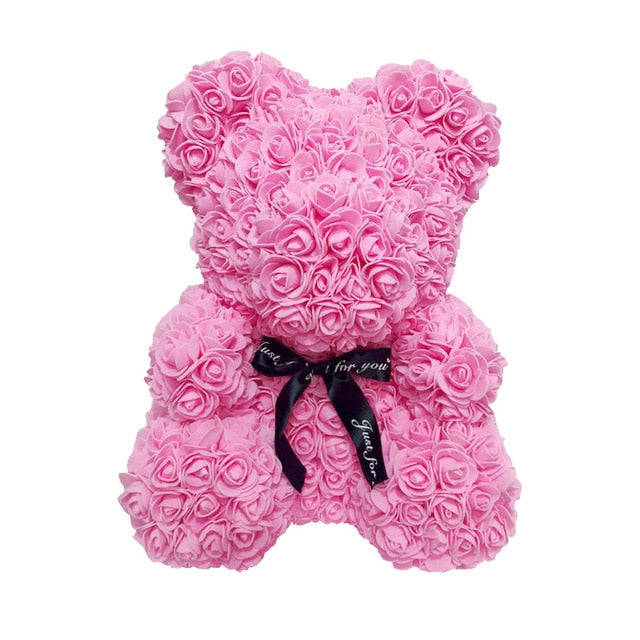 Ours en peluche avec des roses de fleurs artificielles