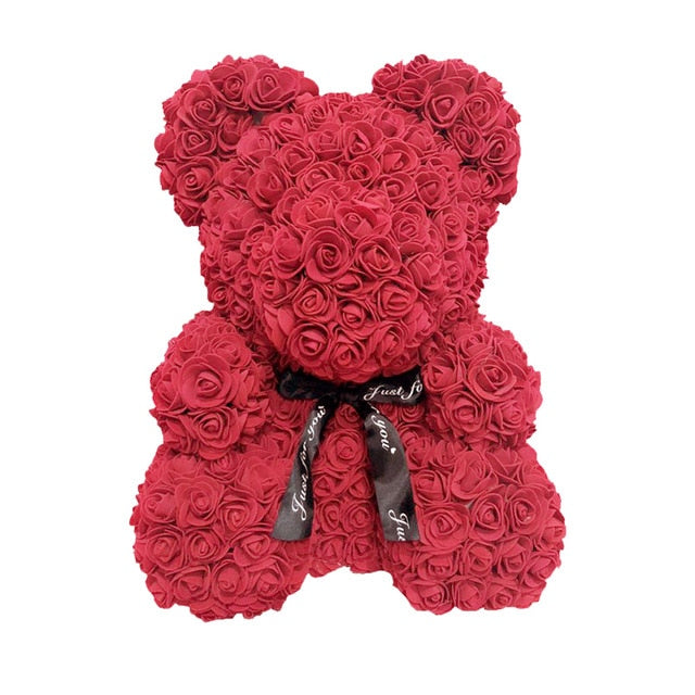 Ours en peluche avec des roses de fleurs artificielles