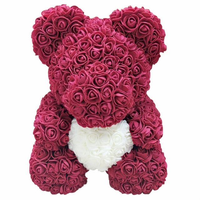 Ours en peluche avec des roses de fleurs artificielles