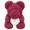 Ours en peluche avec des roses de fleurs artificielles