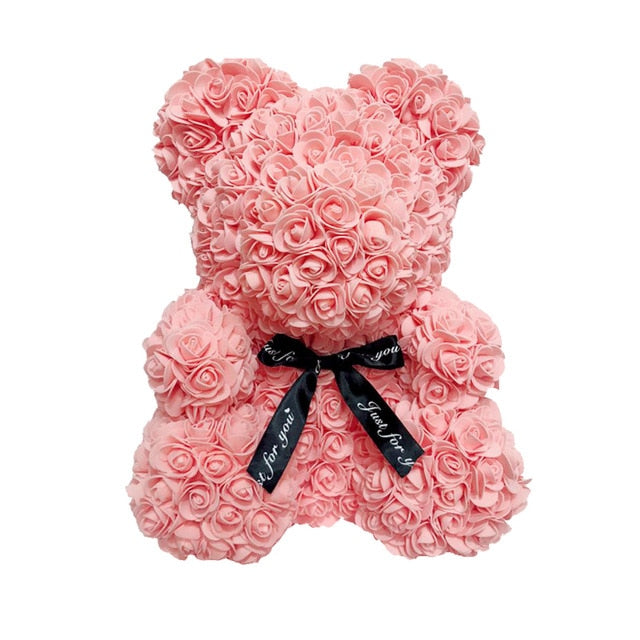 Ours en peluche avec des roses de fleurs artificielles